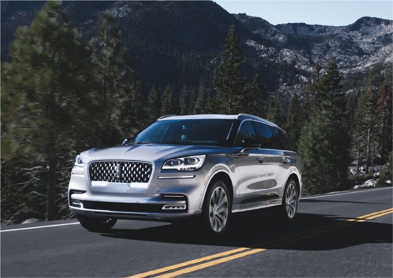 A 2023 Lincoln Aviator® Grand Touring SUV being driven on a winding road to demonstrate the capabilities of all-wheel drive | Fair Oaks Lincoln in Naperville IL