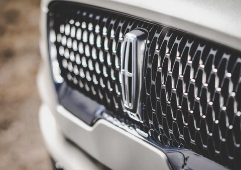 The grille of the 2024 Lincoln Aviator® Reserve model with an eye-catching repeated field of Lincoln Star logo shapes | Fair Oaks Lincoln in Naperville IL