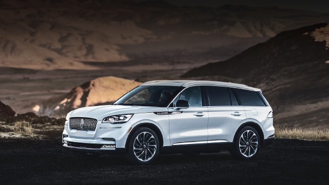 A 2024 Lincoln Aviator® SUV is parked at a mountain overlook | Fair Oaks Lincoln in Naperville IL