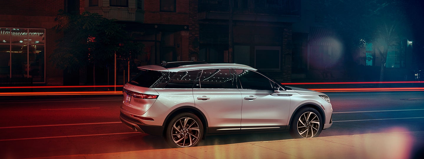 The 2024 Lincoln Corsair® SUV is parked on a city street at night. | Fair Oaks Lincoln in Naperville IL