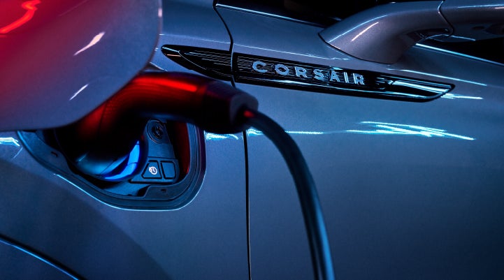 A charger plugged into the charging port of a 2024 Lincoln Corsair® Plug-in Hybrid model. | Fair Oaks Lincoln in Naperville IL