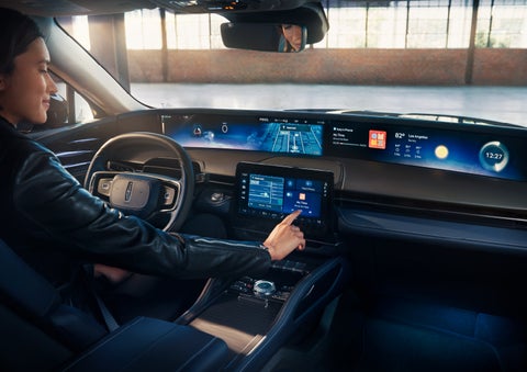 The driver of a 2024 Lincoln Nautilus® SUV interacts with the center touchscreen. | Fair Oaks Lincoln in Naperville IL