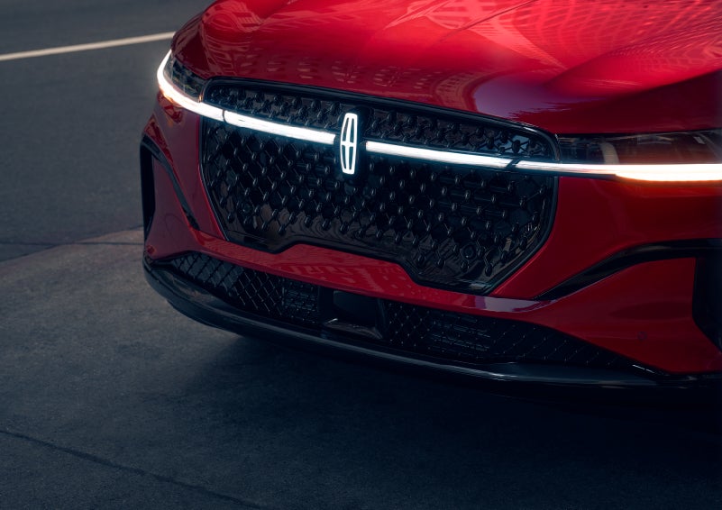 The available front LED light bar and center Lincoln Star logo glow at dusk. | Fair Oaks Lincoln in Naperville IL