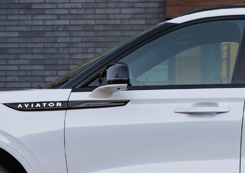 The driver’s side door and fender badging of a white 2026 Lincoln Aviator® SUV are showcased. | Fair Oaks Lincoln in Naperville IL