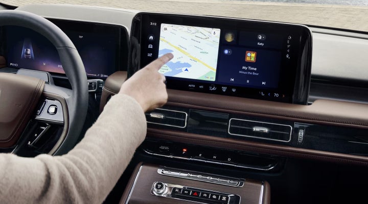 A person is tapping the center display touchscreen of a 2026 Lincoln Aviator® SUV. | Fair Oaks Lincoln in Naperville IL