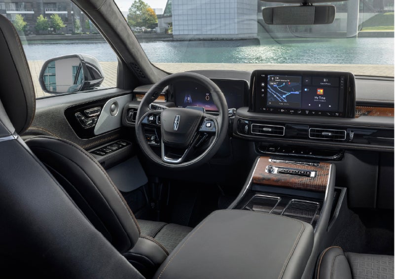 The interior of the 2026 Lincoln Aviator® SUV is shown parked with a view of a harbor through the windshield. | Fair Oaks Lincoln in Naperville IL