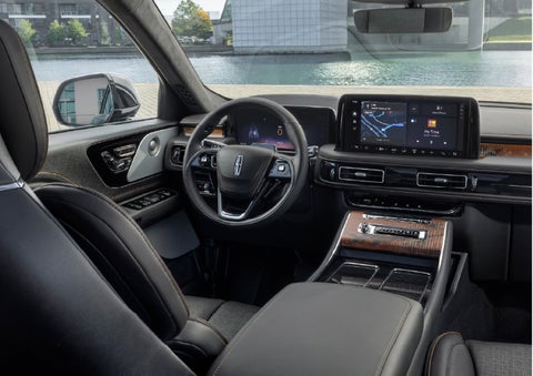 The interior of the 2026 Lincoln Aviator® SUV is shown parked with a view of a harbor through the windshield. | Fair Oaks Lincoln in Naperville IL
