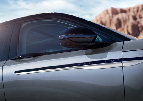 Blue lettering on the side of the vehicle that reads Nautilus indicates the available Hybrid Powertrain. | Fair Oaks Lincoln in Naperville IL