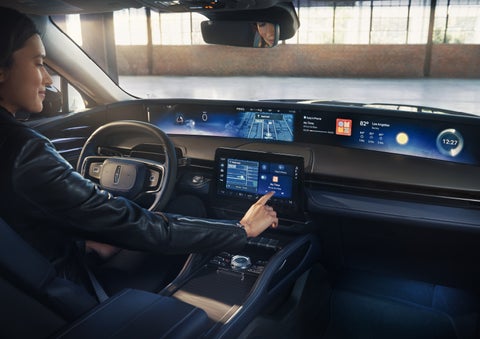 The driver of a 2026 Lincoln Nautilus® SUV interacts with the center touchscreen. | Fair Oaks Lincoln in Naperville IL