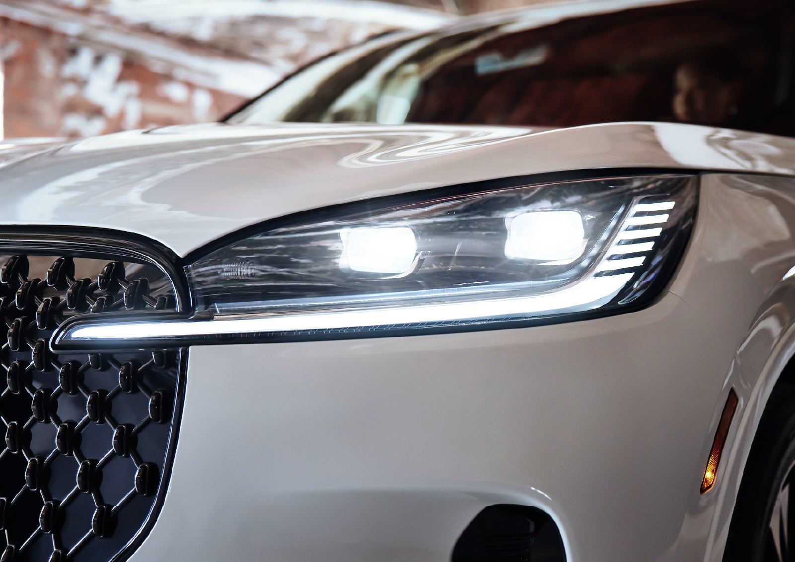 A close-up of a headlamp on the 2027 Lincoln Aviator® SUV is shown. | Fair Oaks Lincoln in Naperville IL