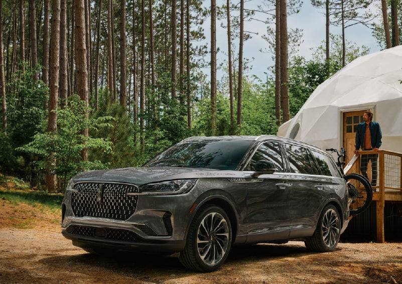 A 2027 Lincoln Aviator® is parked next to a high end glamping site. | Fair Oaks Lincoln in Naperville IL
