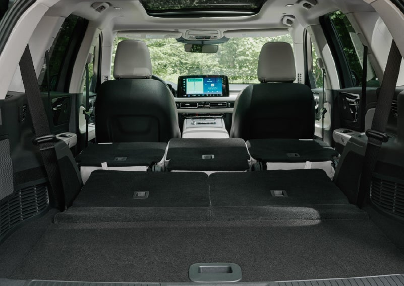 A rear to front view of the interior of a 2027 Lincoln Aviator® Black Label™ SUV shows the third and second rows folded flat | Fair Oaks Lincoln in Naperville IL