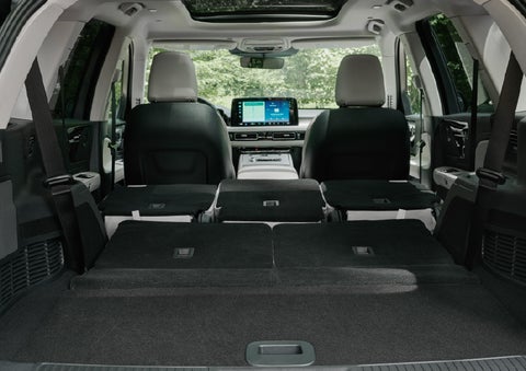 A rear to front view of the interior of a 2027 Lincoln Aviator® Black Label™ SUV shows the third and second rows folded flat | Fair Oaks Lincoln in Naperville IL