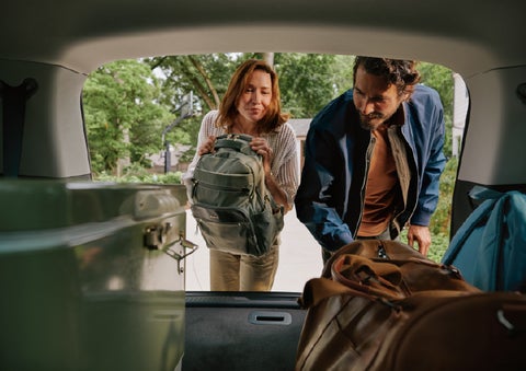 A couple loads luggage into the rear of a 2027 Lincoln Aviator® Black Label™ SUV..e 202 | Fair Oaks Lincoln in Naperville IL