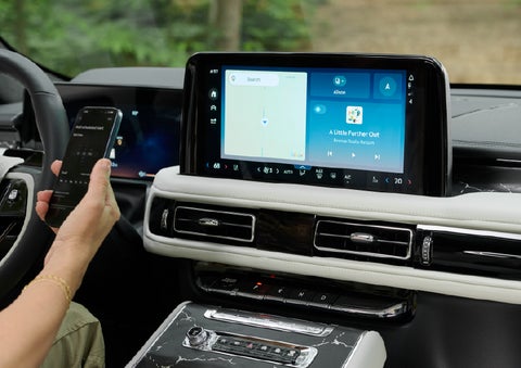 A person pairs thier phone with the center touchscreen of a 2027 Lincoln Aviator® Black Label™ SUV | Fair Oaks Lincoln in Naperville IL